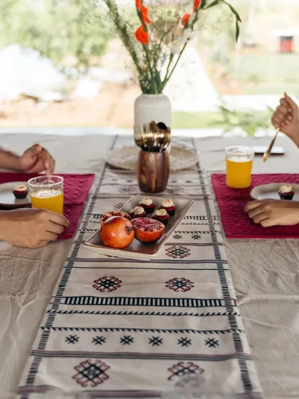 A daytime brunch setup with our tribal-inspired table runner. The monochrome pattern pairs beautifully with both neutral tableware and pops of color from the food and placemats.