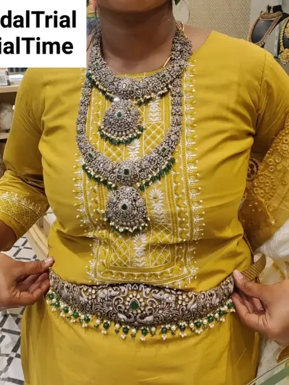 A bride-to-be trying on a silver-finish oxidized jewellery set. This style is perfect for a unique, contemporary ethnic look.