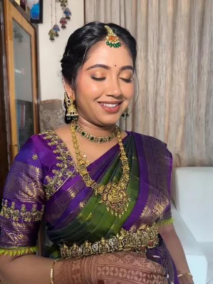 A smiling close-up of the mom-to-be. The soft, shimmery eyeshadow and polished makeup application ensure she looks and feels her absolute best.