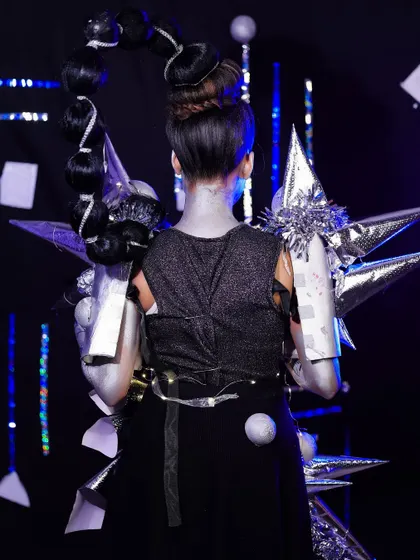 The back view of the robotic look, highlighting the complex bubble braid hairstyle and the detailed construction of the shoulder armor.