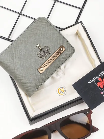 A sleek grey wallet personalized with a crown charm, perfect for a modern and stylish look.