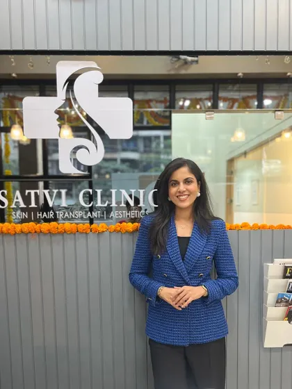 I believe in a partnership with my patients, and it all starts with a warm welcome. Here I am at the entrance to Satvi Skin Clinic, a space I designed to be professional, modern, and comfortable for everyone who walks through our doors.