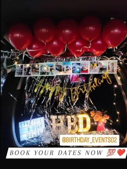 A personalized car trunk surprise. This setup includes a photo garland, a lightbox with a custom message, and red balloons for a romantic touch.