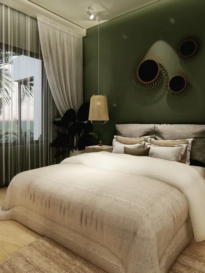 We used a deep olive green for the accent wall in this bedroom to create a cozy and intimate feel. Rattan pendant lights and wooden furniture add a natural, bohemian touch, complemented by the view of palm trees outside.