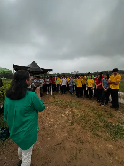 Our team briefs a large group of students from The Shri Ram School under stormy skies, explaining why their work is vital for the region's biodiversity and climate stability.