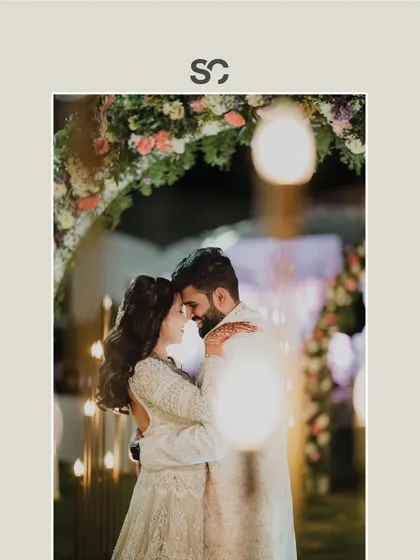 A romantic portrait of Adarsh and Premika, with the bokeh from the fairy lights creating a magical effect.