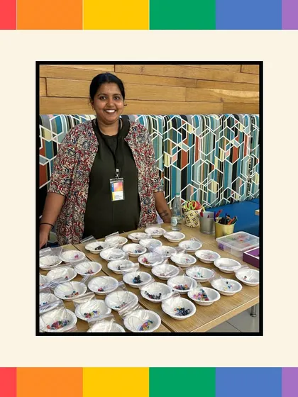 Our instructor stands behind a table prepped for an Ally Bracelet making workshop at Intuit. This activity is designed to be quick, engaging, and to produce a wearable symbol of support.