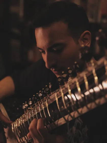 A close-up shot from the 'Mastery' series, focusing on the intricate work of playing the sitar.