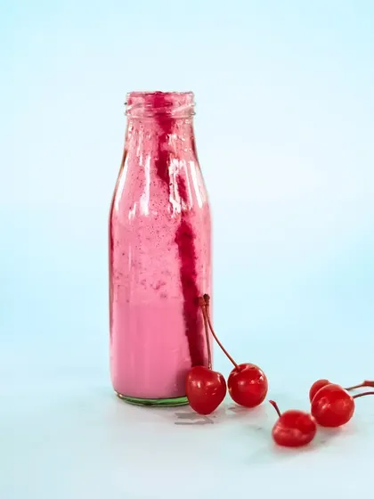 Our 'berry' special Strawberry Milkshake, served in a classic milk bottle with fresh cherries.
