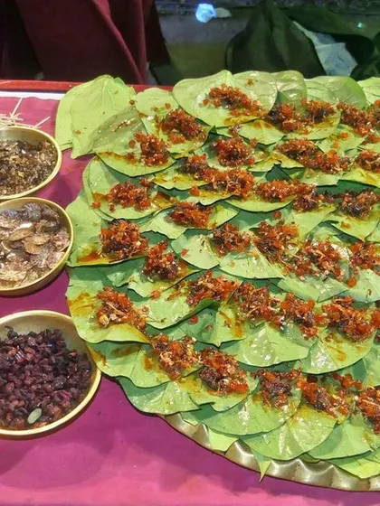 A live paan counter with a wide assortment of fillings like gulkand, saunf, and chopped nuts. Each paan is made to order according to the guest's preference.