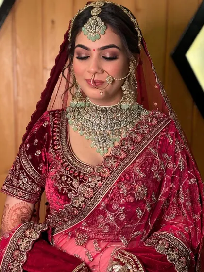 A detailed shot of the eye makeup for this luxe bridal look. The soft, smoky blend enhances her eyes, adding depth and dimension that complements her heavy jewelry and velvet outfit.