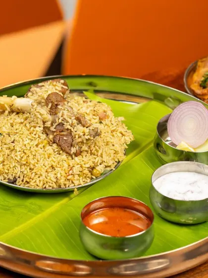 A full meal experience featuring my Bannur Mutton Palav. Served on a traditional banana leaf with onion raita and salan, this showcases the complete, flavourful meal as it's meant to be enjoyed.