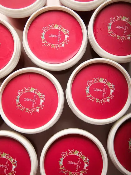 An overhead shot of our signature red ice cream tubs, ready to be filled with freshly churned goodness. A promise of quality in every package.