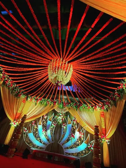A view from inside the mandap, looking up at the ceiling decor. I used strings of red flowers radiating from a central floral chandelier, creating a stunning sunburst effect that adds drama and detail to the sacred space.