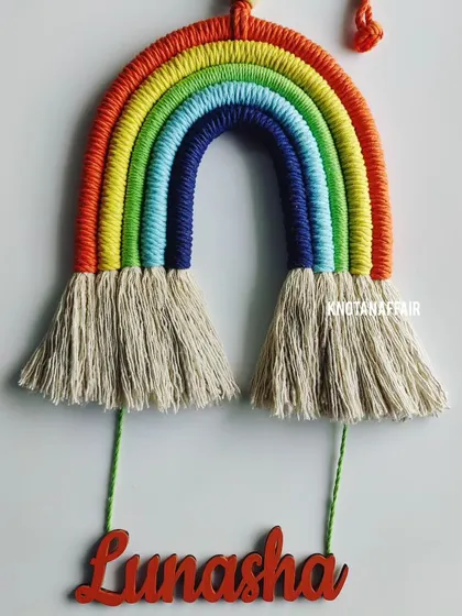 A vibrant macrame rainbow with the name 'Lunasha'. These personalized wall hangings are a great eco-friendly and sustainable gifting option for your loved ones.