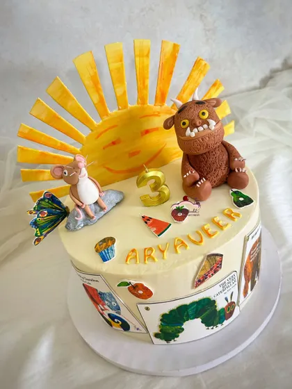 A storybook-themed cake bringing together two beloved classics: 'The Gruffalo' and 'The Very Hungry Caterpillar'. All the characters and details are handcrafted from sugar.