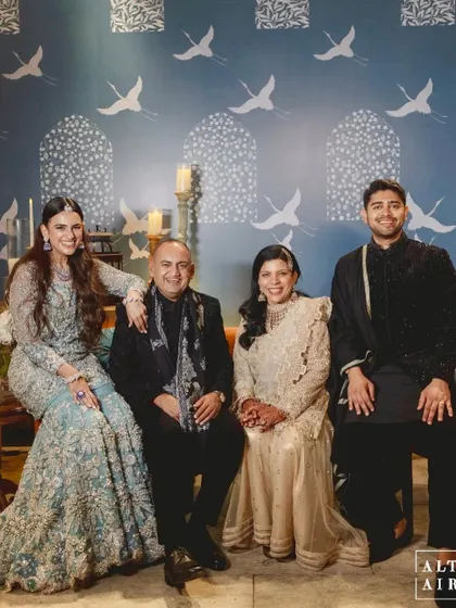 The beautiful family posing against a custom backdrop at the 'Midnight Marrakesh' event. The hand-painted crane motif added an artistic and personal touch to the decor.