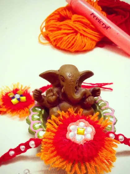 An easy, last-minute Rakhi you can make at home. This design uses wool, beads, and a 3D liner to create a beautiful and meaningful Rakhi for Raksha Bandhan.