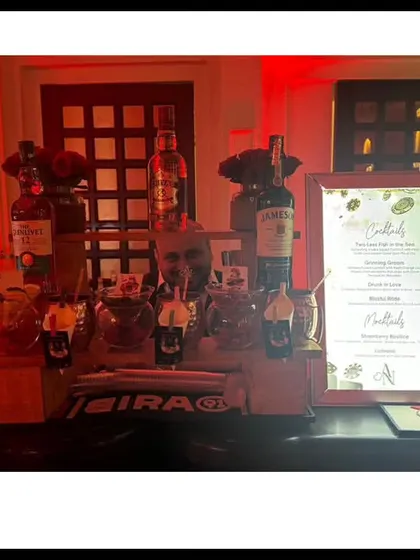 A festive bar setup with red and green lighting for a Christmas-themed party. The menu includes a special Whiskey Sour Cocktail Bar, perfect for the occasion.