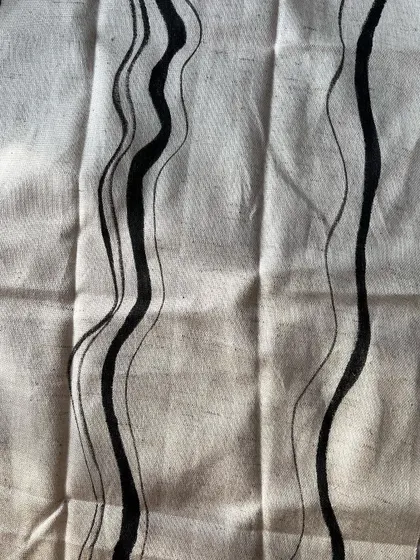 The detail of the hand-painted wavy lines shows the artistry involved. This technique allows for bespoke patterns that cannot be replicated by machine printing.
