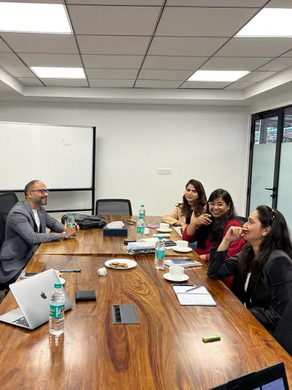 A candid moment of discussion during a professional development workshop. Creating a relaxed atmosphere encourages open dialogue and peer to peer learning among professionals.