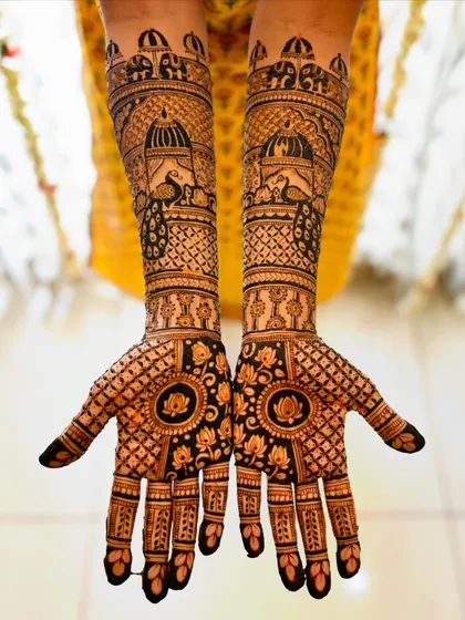 A straight-on view of the front design, with peacocks on the arms and lotus mandalas on the palms.