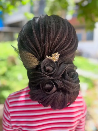 The rose bun captured in natural light, showcasing the artistry and skill required to create such a detailed and beautiful updo.