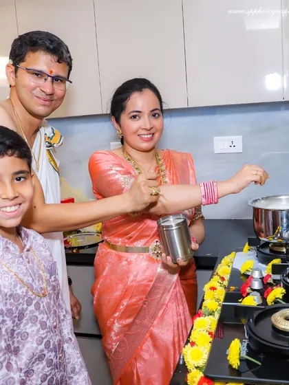 A family participating in the rituals of their Griha Pravesh. This photo captures the family's happiness and the traditional elements of the ceremony.