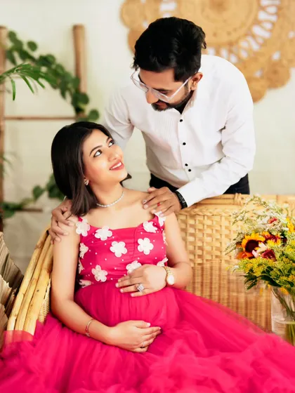 A close-up, intimate moment between an expecting couple, filled with love and gentle smiles.