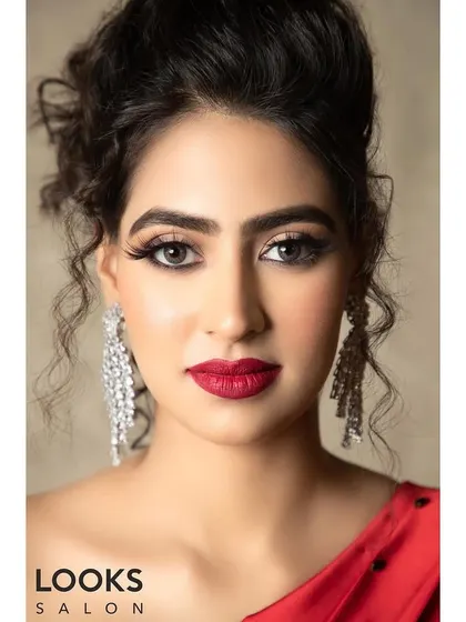 A direct, confident portrait of the red dress look. The matte red lipstick is the hero here, perfectly applied to create a powerful and glamorous statement.