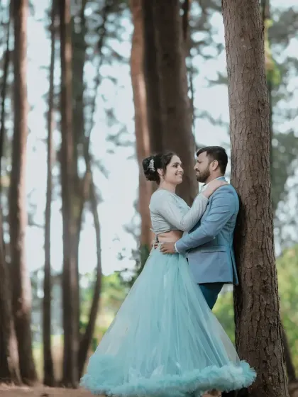 A romantic pose against a tree. The light blue two piece gown is a unique and beautiful choice for a pre-wedding photoshoot.