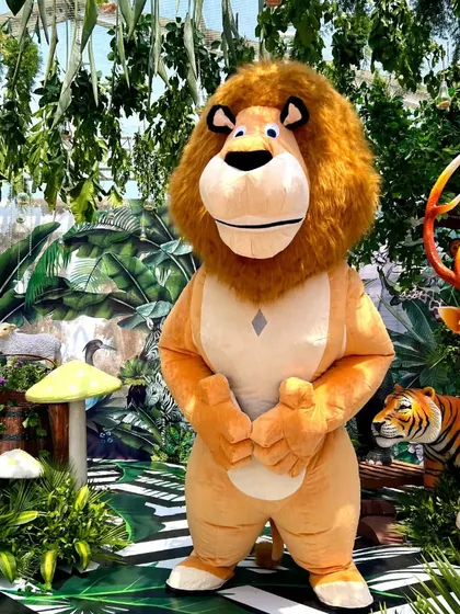 Our Lion mascot stands proudly in a jungle-themed party setup. We work with your decor to make our character appearances feel seamless and immersive.