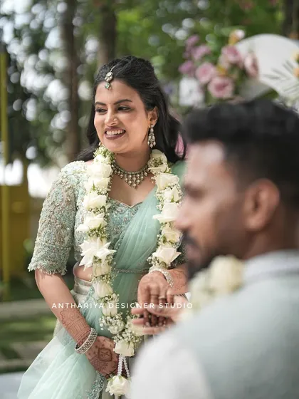 A beautiful moment from Anupa's engagement, wearing a pastel mint lehenga with a fully embroidered blouse.
