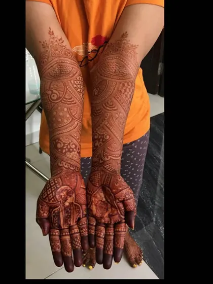 This image shows the beautiful, deep reddish-brown stain of a bridal mehendi after the paste has been removed. The detailed portrait and patterns are crisp and clear.