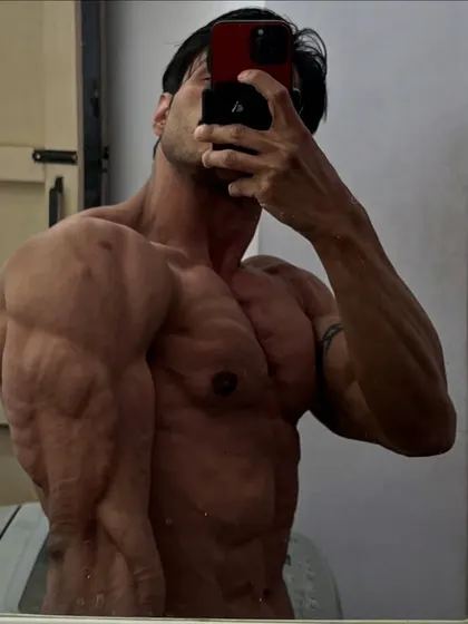 A side chest pose showing the density and separation in my pecs and delts. This is the result of focusing on both compound presses and isolation work.