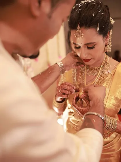 A close-up of a traditional wedding ritual. The makeup is designed to be resilient and look perfect even in intimate, detailed photographs.