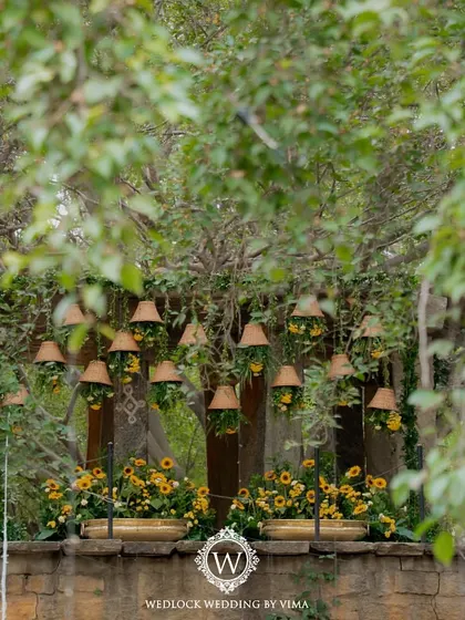For this Haldi, we focused on a vibrant yellow theme with rustic touches. We used hanging cane baskets filled with yellow flowers, lush greens, and traditional brass urlis to create a warm and sunny celebration.