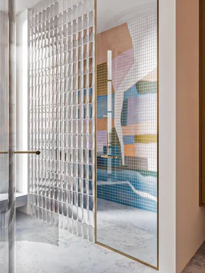 A reflection in the mirror shows the beautiful, abstract mosaic pattern, which adds a splash of summery color to the space.