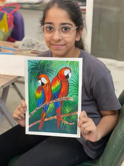 These colorful parrots were painted by a student using poster colors. This project helps them practice blending bright colors and painting fine details like feathers.
