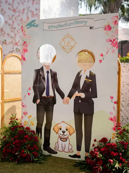 A fun, interactive photo cutout board for guests, featuring caricatures of the couple.