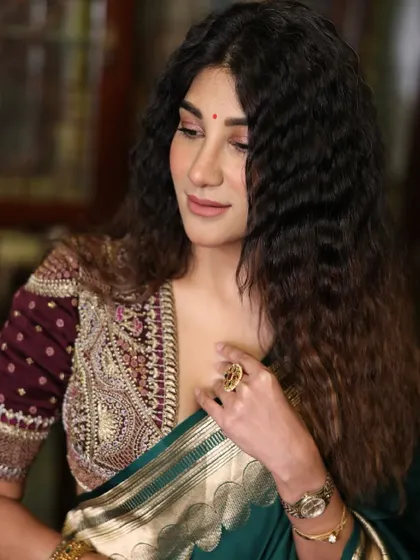 A close-up of the heavily embroidered blouse. Pairing a detailed blouse with a simple saree is a great way to create a balanced and elegant ethnic look.