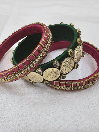 An angled view of the green and pink silk thread bangles, highlighting the different layers and embellishments.