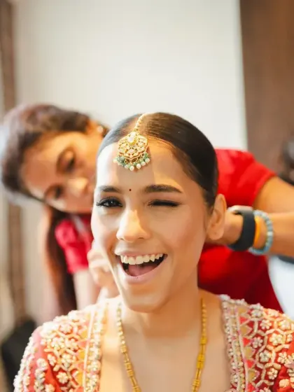 A fun, candid moment where the bride gives a playful wink to the camera while getting ready. It captures her vibrant personality and excitement for the day ahead.