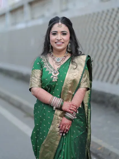 A beautiful outdoor portrait of the bride. The natural light highlights her glowing skin and the soft, blended makeup.