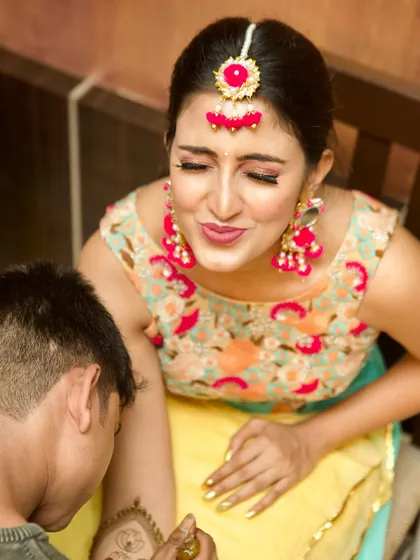 A candid moment as the bride gets her Mehendi done. The makeup is subtle enough for her to feel comfortable, yet elegant enough for the celebratory occasion.