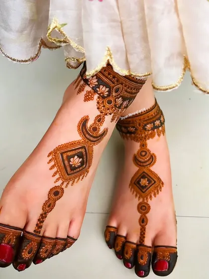 A beautiful shot of both feet with the Arabic-inspired geometric design.