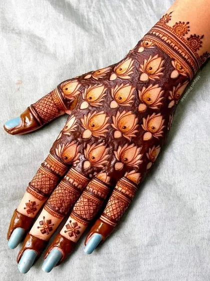 A unique design covering the back of the hand with repeating lotus bud motifs, creating a beautiful and textured pattern.