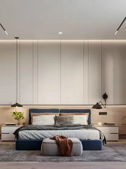A minimalist bedroom with a low-profile bed and floor-to-ceiling wardrobes that provide ample storage while maintaining a clean look.