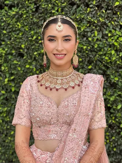 Aarushi was a vision in her pastel pink lehenga for her day wedding. We kept the makeup fresh and radiant, with a clean winged liner and a soft pink lip. These portraits capture the look from every beautiful angle.