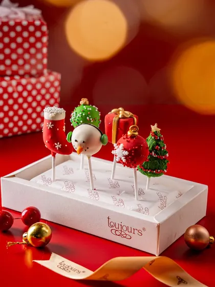 A box of festive cake pops, decorated as snowmen, Christmas trees, and ornaments. These bite-sized treats are fun, easy to share, and a guaranteed hit at any holiday party.
